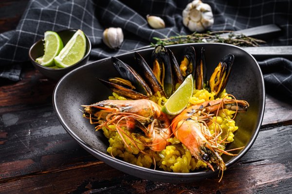 What's the Key to Crafting a Savory Spanish Paella with Seafood and Saffron?